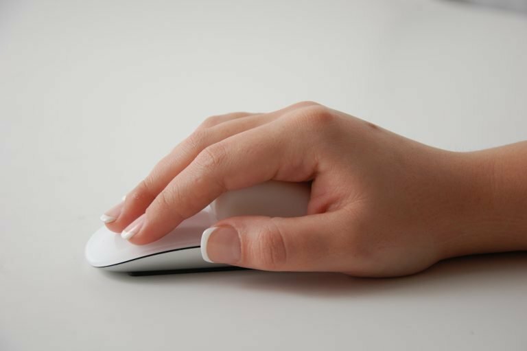 A person using the Apple Magic Mouse with the MMFixed attached